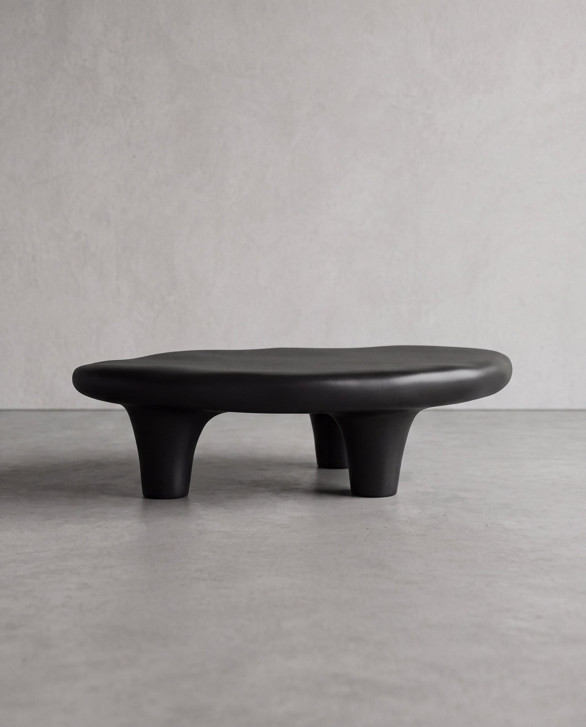 KANO Coffee Table – low sculptural matte black fiberglass coffee table with irregular silhouette