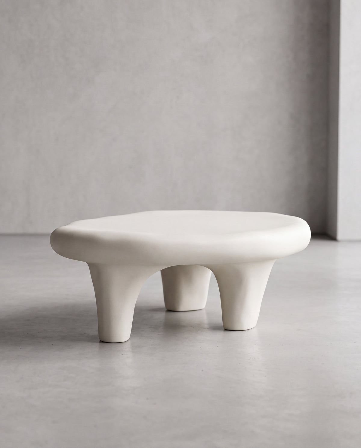 NUBA Coffee Table – angled view of the rounded matte white surface and organic legs