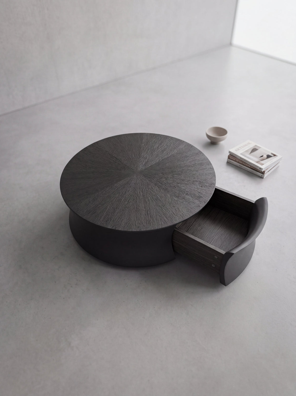 AKI Coffee Table – angled view showing the low circular form and integrated storage